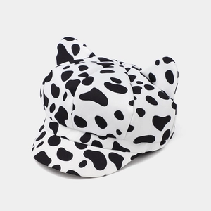Fashionable retro newsboy hat with cat ears and stylish black and white cow print pattern