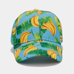Detail of tropical banana and green leaf print on a vibrant sky blue canvas baseball cap