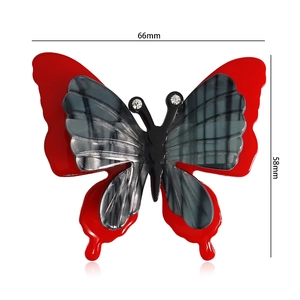 Detailed view of handmade acrylic butterfly brooch with size markings 66mm by 58mm