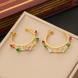 Detail of gold hoop earrings with multi-colored round crystals on a jewelry box