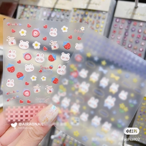 Detailed view of 5D embossed nail stickers featuring cute rabbits and strawberries