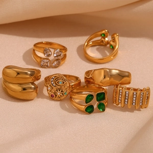 Detail of 18K gold plated ring set with colorful zircon stones on silk background