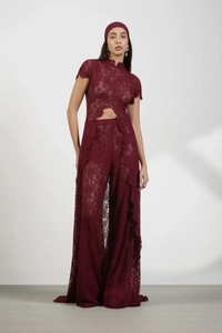 Detail of dark red lace two-piece set featuring hollowed-out top and wide-leg trousers