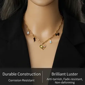 Detail of colorful daisy heart and bow charms on a gold chain necklace for women