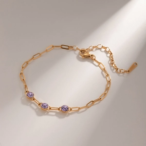 Close-up of 18k gold-plated stainless steel chain bracelet with purple zircon stones