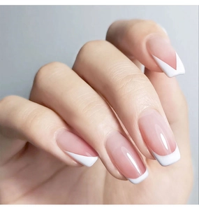 Close-up of pink and white V-shape French manicure tips with glossy trapezoid finish