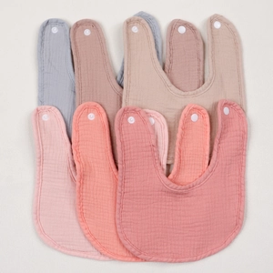 Detailed view of six organic cotton gauze baby bibs in assorted muted morandi colors