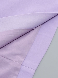 Close-up of lavender V-neck dress showing twill fabric texture and neat stitching detail