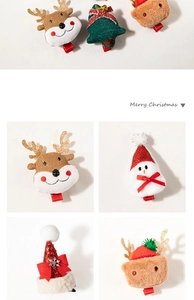 Close-up of plush Christmas hair clips featuring reindeer, tree and bear designs