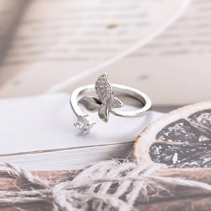 Adjustable silver butterfly open ring with micro-pave cubic zirconia on book background