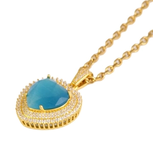 Elegant gold necklace featuring a blue heart-shaped topaz pendant with diamond halo