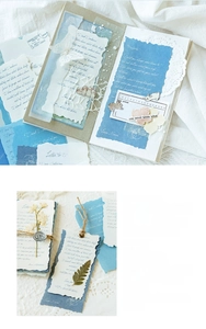 Detail view of vintage scrapbooking kit with aged paper, dried leaves and hemp rope
