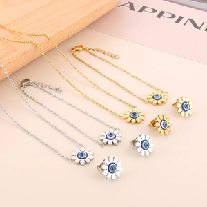 Macro detail of daisy jewelry set with evil eye center in gold and silver finishes