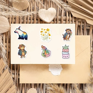 Flat lay of cute aesthetic DIY stickers with cat and bear motifs on kraft paper background