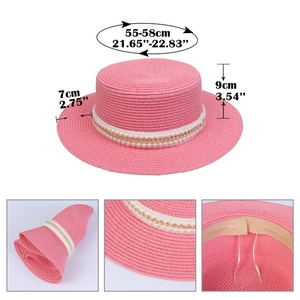 Detail view of pink straw hat with pearl gold chain and foldable woven texture features