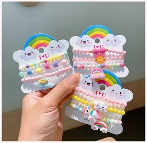 Detailed view of colorful acrylic beaded bracelets with unicorn and rainbow charms for girls
