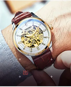 Wrist shot of automatic mechanical watch with white hollow dial and brown leather strap