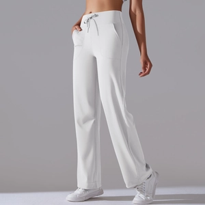 Detail of high waisted white wide leg yoga pants with drawstring and side pockets