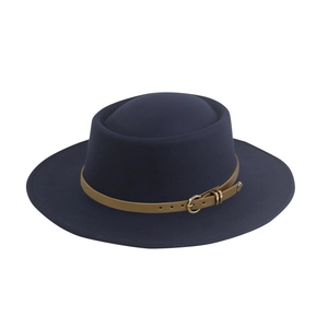 Close-up of navy wool fedora hat featuring a brown leather band and gold buckle detail