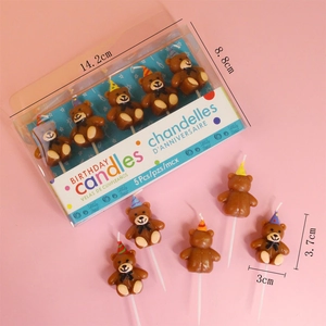 Detailed size view of five brown cartoon bear birthday candles with party hats