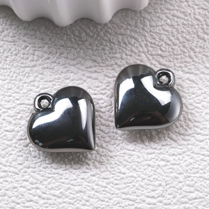 Detailed view of dark grey silver-plated acrylic heart charms with smooth metallic finish