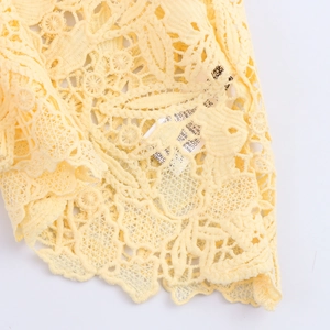 Elegant yellow sleeveless lace top and skirt set with floral mesh texture details