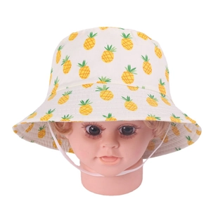 Detailed view of kids white sun hat with yellow pineapple print and chin strap
