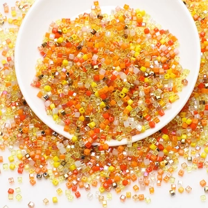Macro shot of assorted warm-toned square glass beads for DIY jewelry and hair accessories