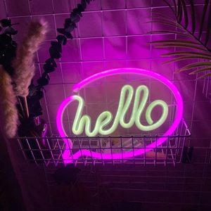 Close-up of pink and yellow LED hello neon sign in a white basket for room decor