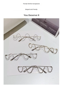 Close-up of wavy metal frames with rhinestone details on a minimalist background