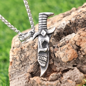 Gothic skull dagger pendant necklace in vintage silver finish on a rustic wood background