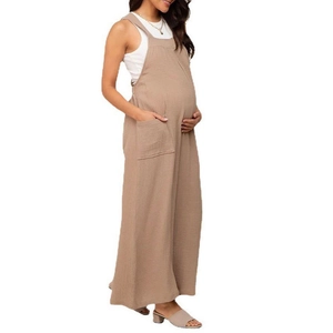 Detail view of khaki maternity jumpsuit with wide legs and breathable cotton texture