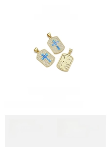 Detail view of 15x24mm copper 18K gold plated cross pendant with blue opal and zircons