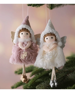 Detail of plush Christmas angel ornaments in pink and white with snowflake accents