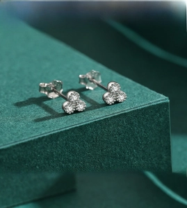 Macro shot of s925 silver stud earrings with three minimalist sparkling zircon stones