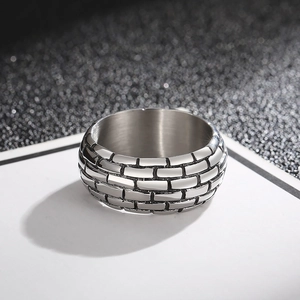 Macro shot of men's vintage steel ring with black brick wall texture and gothic finish