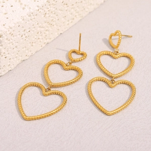 Detail of 18K gold-plated stainless steel triple heart earrings with snake skin texture