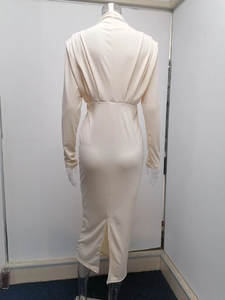 Detail of slim-fit off-white long sleeve dress with waist ruching and back slit