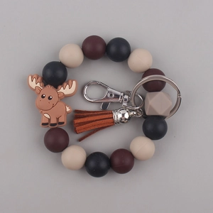 Detail view of silicone bead keychain bracelet with brown tassel and cute elk charm accessory