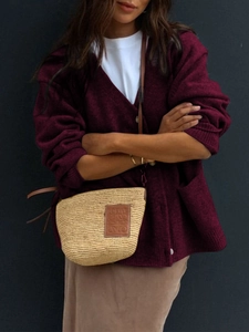 Detailed knit texture of burgundy V-neck cardigan with high-quality buttons