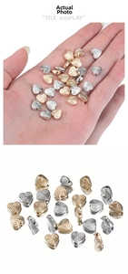 Macro shot of gold and silver heart beads with spiral texture for jewelry making