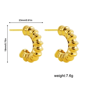 Detail showing 23mm x 19mm gold croissant hoop earrings with 18k gold plating texture