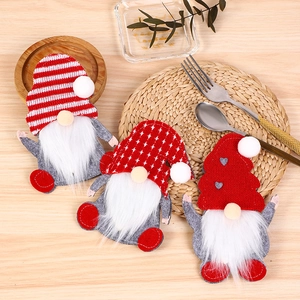 Set of three festive Christmas gnome cutlery holders with striped and heart hats