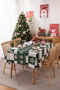 Detail of Christmas tablecloth with gingerbread men and snowflakes on a plaid background