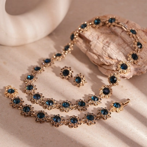 Vintage floral jewelry set with blue gemstones and diamonds in gold finish