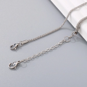 Detailed close-up of woven chain bracelet with silver finish and adjustable lobster clasp