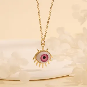 Close-up of pink devil's eye pendant necklace with 18k gold plated eyelashes design