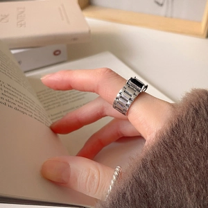 Detail of 925 sterling silver ring with black stone and watch strap chain design