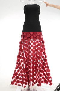 Detail of red 3D circular sequins on translucent mesh of a strapless evening gown