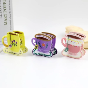 Three-piece acrylic coffee cup hair claws in yellow, purple, and pink floral designs